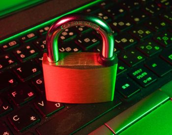 A padlock resting on a keyboard, symbolizing security.